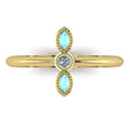 A top-down view of the Astraea trilogy ring featuring two marquise-cut aquamarines flanking a central brilliant diamond set in yellow gold.