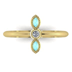 A top-down view of the Astraea trilogy ring featuring two marquise-cut aquamarines flanking a central brilliant diamond set in yellow gold.
