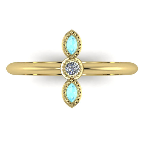 A top-down view of the Astraea trilogy ring featuring two marquise-cut aquamarines flanking a central brilliant diamond set in yellow gold.