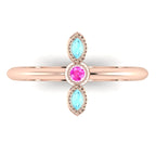 Top view of Astraea Trilogy 18ct rose gold ring with a central pink sapphire and two marquise-cut aquamarines.