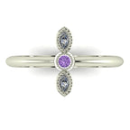 Top down view of an Astraea Trilogy ring featuring a central oval violet sapphire and two round brilliant diamonds in 18ct white gold.