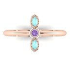 Top view of Astraea Trilogy 18ct rose gold ring featuring a central violet sapphire and two marquise aquamarines.