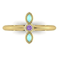 Top view of Astraea Trilogy 18ct yellow gold ring with a central violet sapphire and two marquise-cut aquamarines.