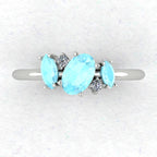 A top-down view of the Atlantis engagement ring, featuring an asymmetrical cluster of pale blue aquamarines and brilliant diamonds in a contemporary setting.