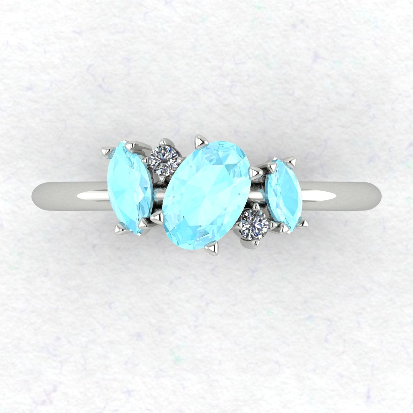 A top-down view of the Atlantis engagement ring, featuring an asymmetrical cluster of pale blue aquamarines and brilliant diamonds in a contemporary setting.