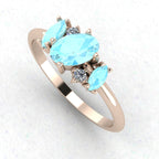 An angled perspective of the Atlantis ring, showcasing the organic, contemporary design and the soft colour contrast between the blue stones and the rose gold band.