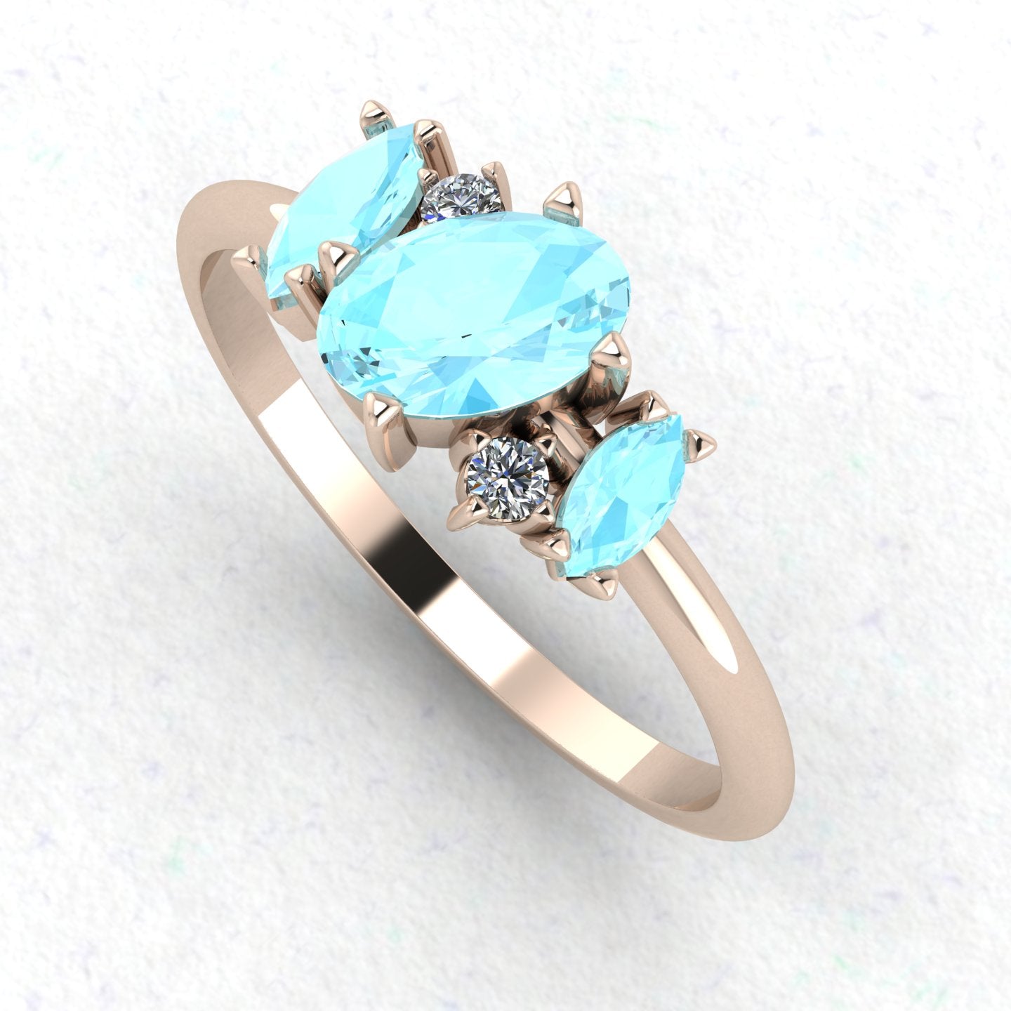 An angled perspective of the Atlantis ring, showcasing the organic, contemporary design and the soft colour contrast between the blue stones and the rose gold band.