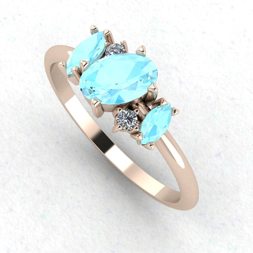 An angled perspective of the Atlantis ring, showcasing the organic, contemporary design and the soft colour contrast between the blue stones and the rose gold band.