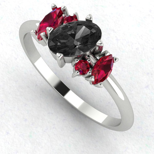 An angled perspective of the Atlantis ring, showcasing the dramatic contrast of the black diamond and crimson rubies against the bright, polished finish of the white gold band.