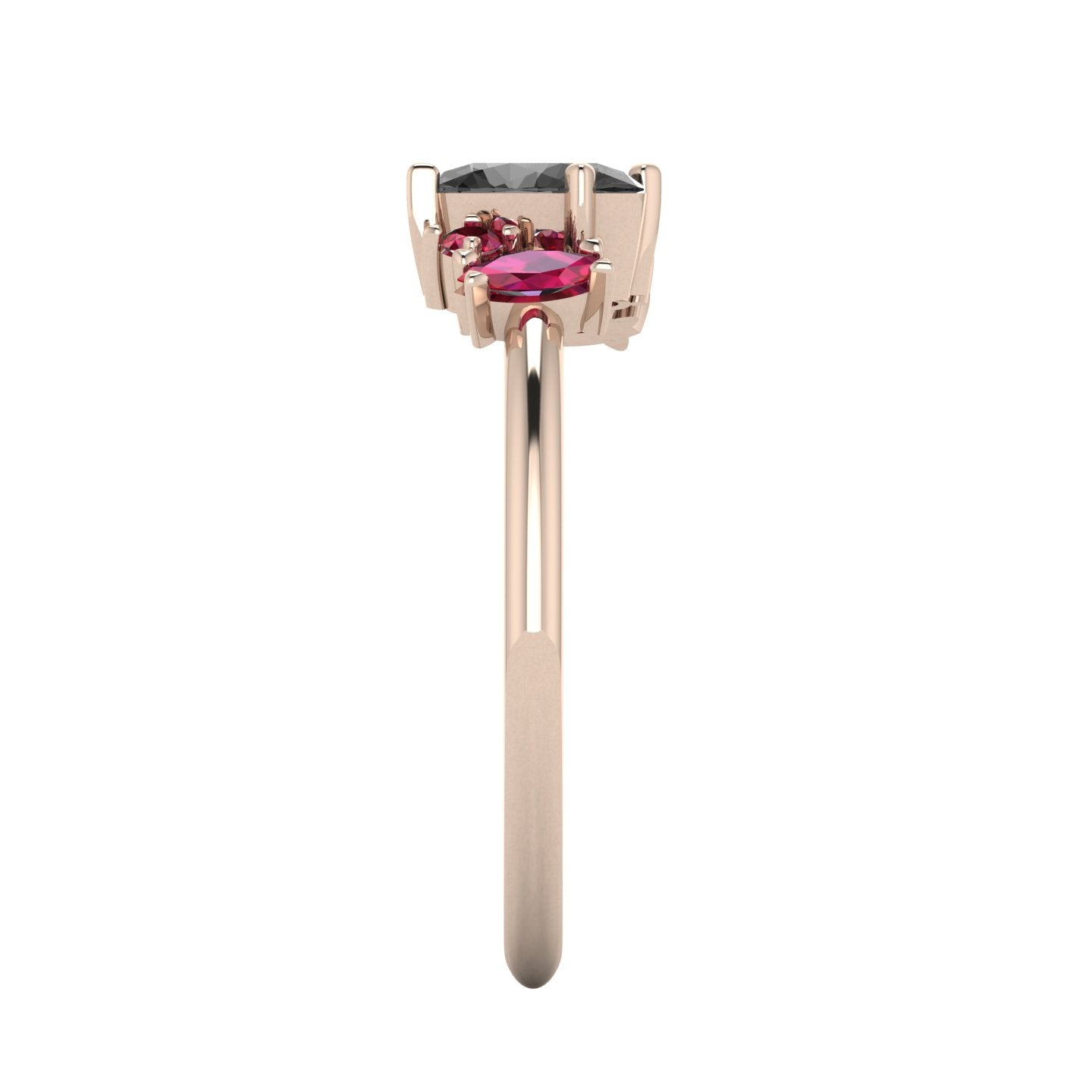 A side profile shot of the Atlantis asymmetrical ring, showcasing the handmade, textured settings and the unique elevations of the hand-set rubies and black diamond.