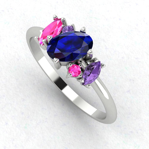 An angled perspective of the Atlantis ring, showcasing the organic arrangement of the blue rainbow sapphires against the polished white gold or platinum band.