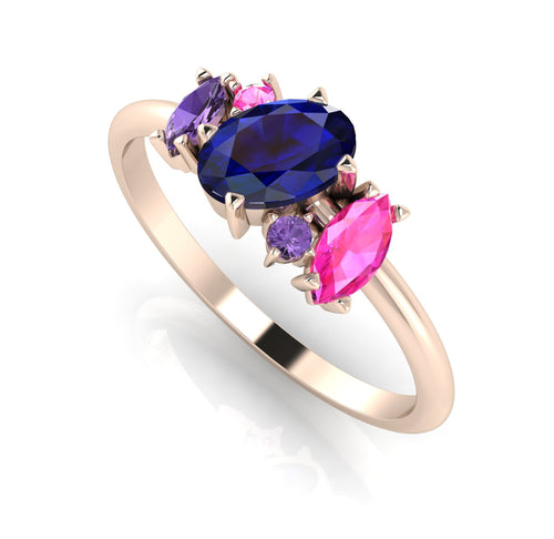 An angled perspective of the Atlantis ring, showcasing the organic design and the unique colour palette of blue sapphires against the rose gold band.