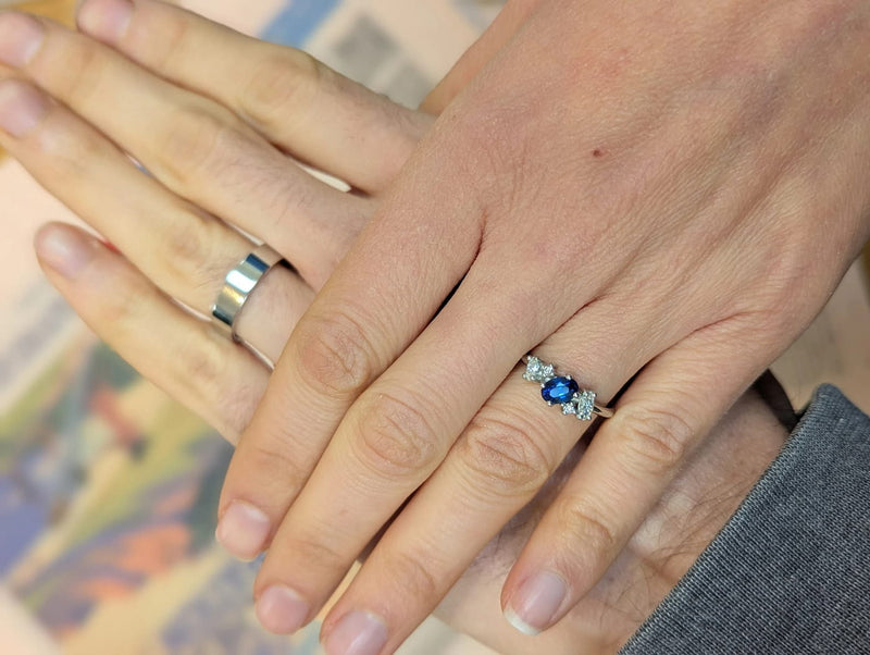 Client wearing the Atlantis unusual sapphire and diamond cluster engagement ring in 18ct white gold, handmade in London