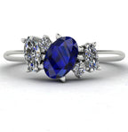 Front view of the Atlantis engagement ring, featuring an asymmetrical cluster of deep blue sapphires and sparkling diamonds set in white gold or platinum.