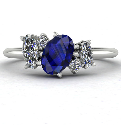 Front view of the Atlantis engagement ring, featuring an asymmetrical cluster of deep blue sapphires and sparkling diamonds set in white gold or platinum.