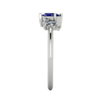A side profile shot of the Atlantis asymmetrical ring, detailing the unique heights of the sapphire and diamond settings and the polished finish of the band.