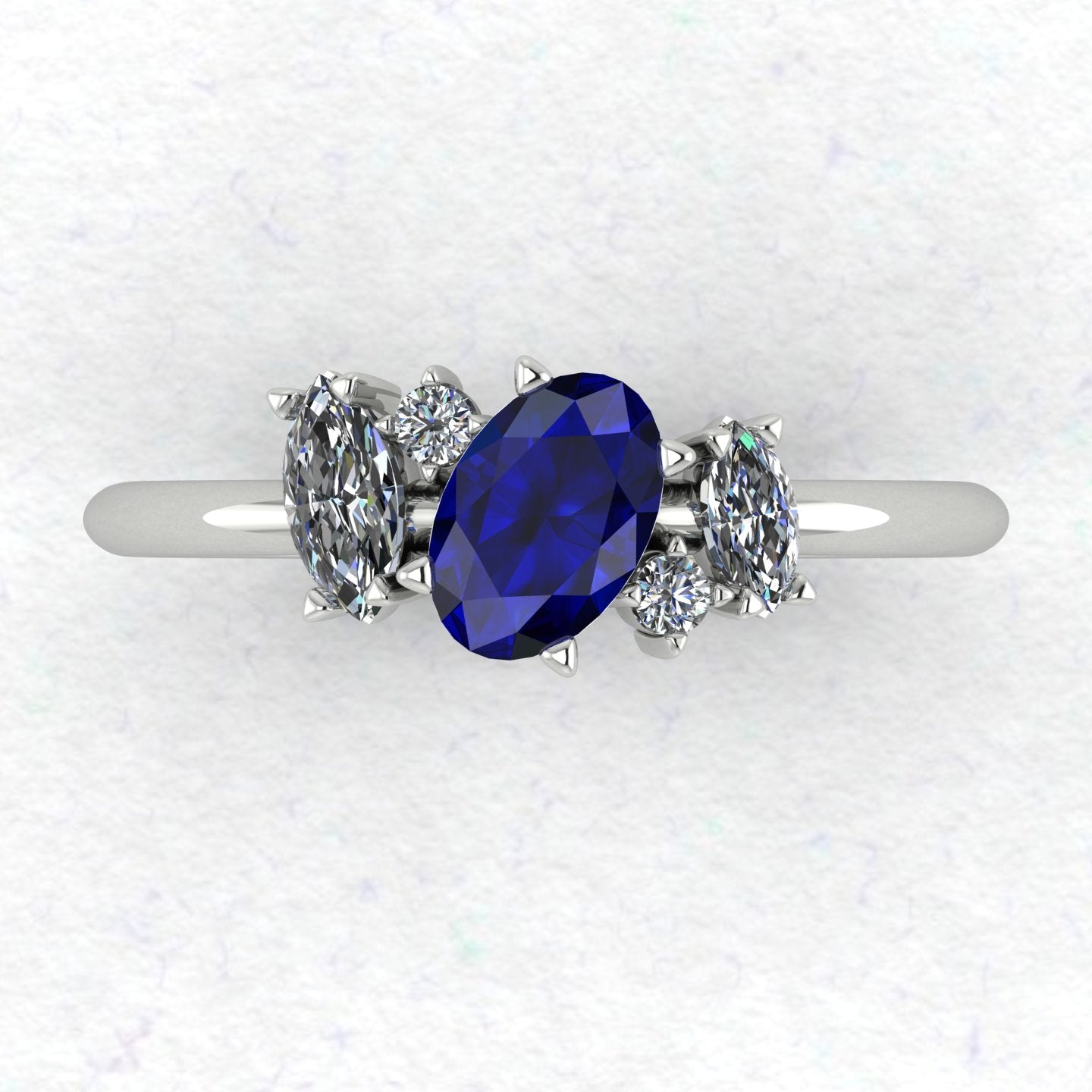 A top-down view of the Atlantis engagement ring, featuring an asymmetrical cluster of deep blue sapphires and sparkling diamonds set in white gold or platinum.