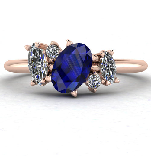 Front view of the Atlantis engagement ring, featuring a cluster of deep blue sapphires and sparkling diamonds in a bespoke asymmetrical 18ct rose gold setting.
