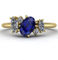 Front view of the Atlantis engagement ring, featuring an asymmetrical cluster of deep blue sapphires and brilliant diamonds set in 18ct yellow gold.