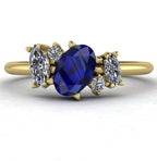 Front view of the Atlantis engagement ring, featuring an asymmetrical cluster of deep blue sapphires and brilliant diamonds set in 18ct yellow gold.