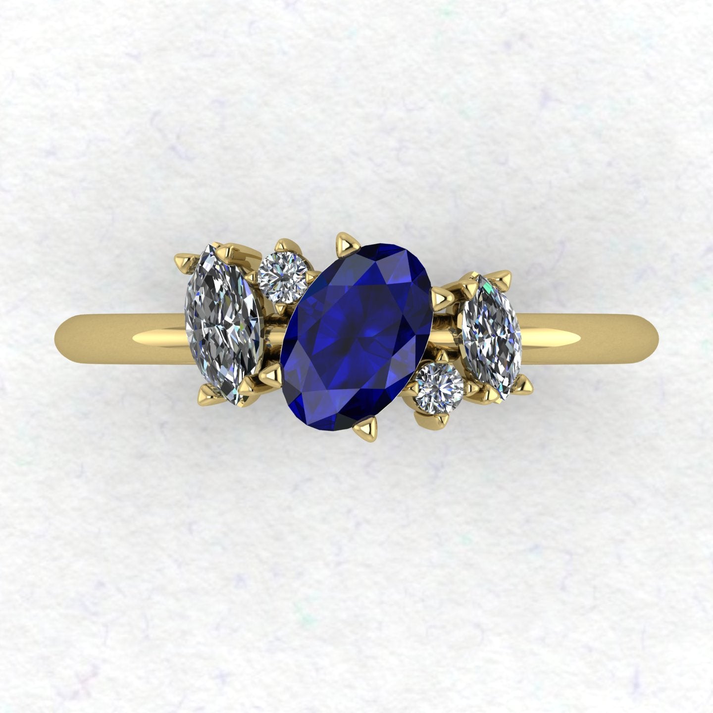A top-down view of the Atlantis engagement ring, featuring an asymmetrical cluster of deep blue sapphires and brilliant diamonds set in 18ct yellow gold.