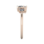 A side profile shot of the Atlantis asymmetrical ring, detailing the varying heights of the diamond settings and the textured craftsmanship of the rose gold.