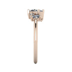 Side profile of Atlantis asymmetrical diamond engagement ring in 18ct rose gold showing varying stone heights and slim band