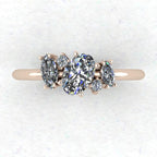 Top-down view of Atlantis asymmetrical diamond engagement ring in 18ct rose gold showing oval centre with flanking marquise diamonds