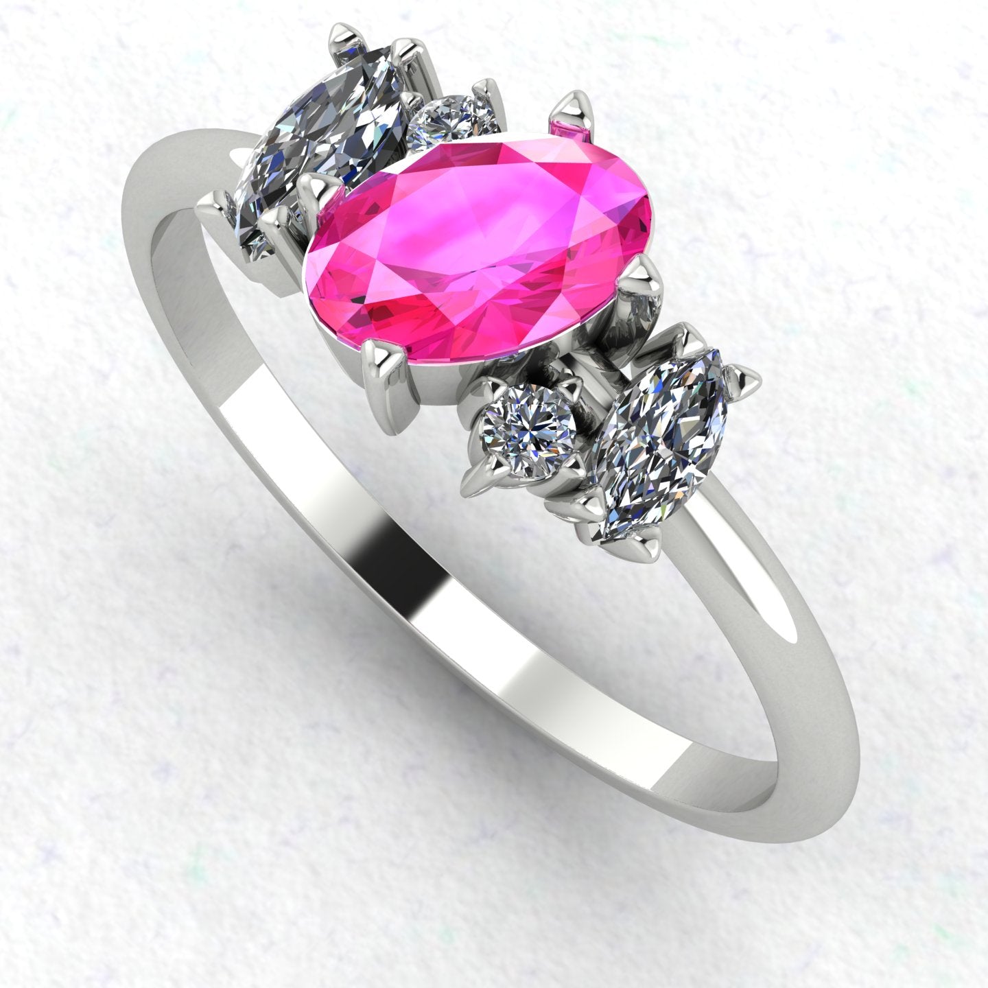 An angled perspective of the Atlantis ring, showcasing the organic, contemporary design and the striking contrast of pink sapphires against the polished white metal band.