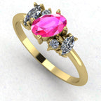 An angled perspective of the Atlantis ring, showcasing the organic, contemporary design and the rich contrast of pink sapphires against the yellow gold band.