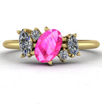 Front view of the Atlantis engagement ring, featuring an asymmetrical cluster of vivid pink sapphires and sparkling diamonds in an 18ct yellow gold setting.