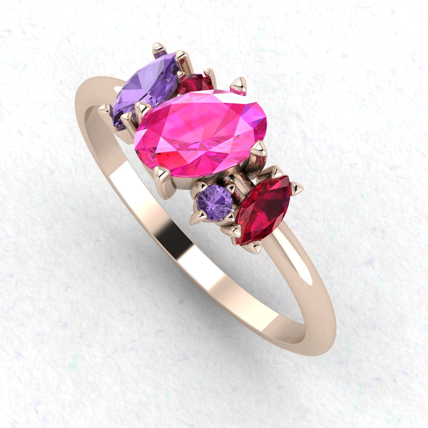 An angled perspective of the Atlantis ring, highlighting how the pink and violet gemstones complement the warm tones of the rose gold band.