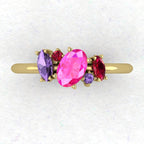 A top-down view of the Atlantis ring featuring an asymmetrical cluster of pink and violet sapphires paired with a ruby in 18ct yellow gold.