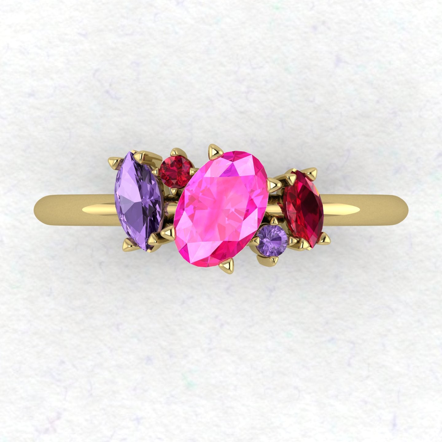 A top-down view of the Atlantis ring featuring an asymmetrical cluster of pink and violet sapphires paired with a ruby in 18ct yellow gold.