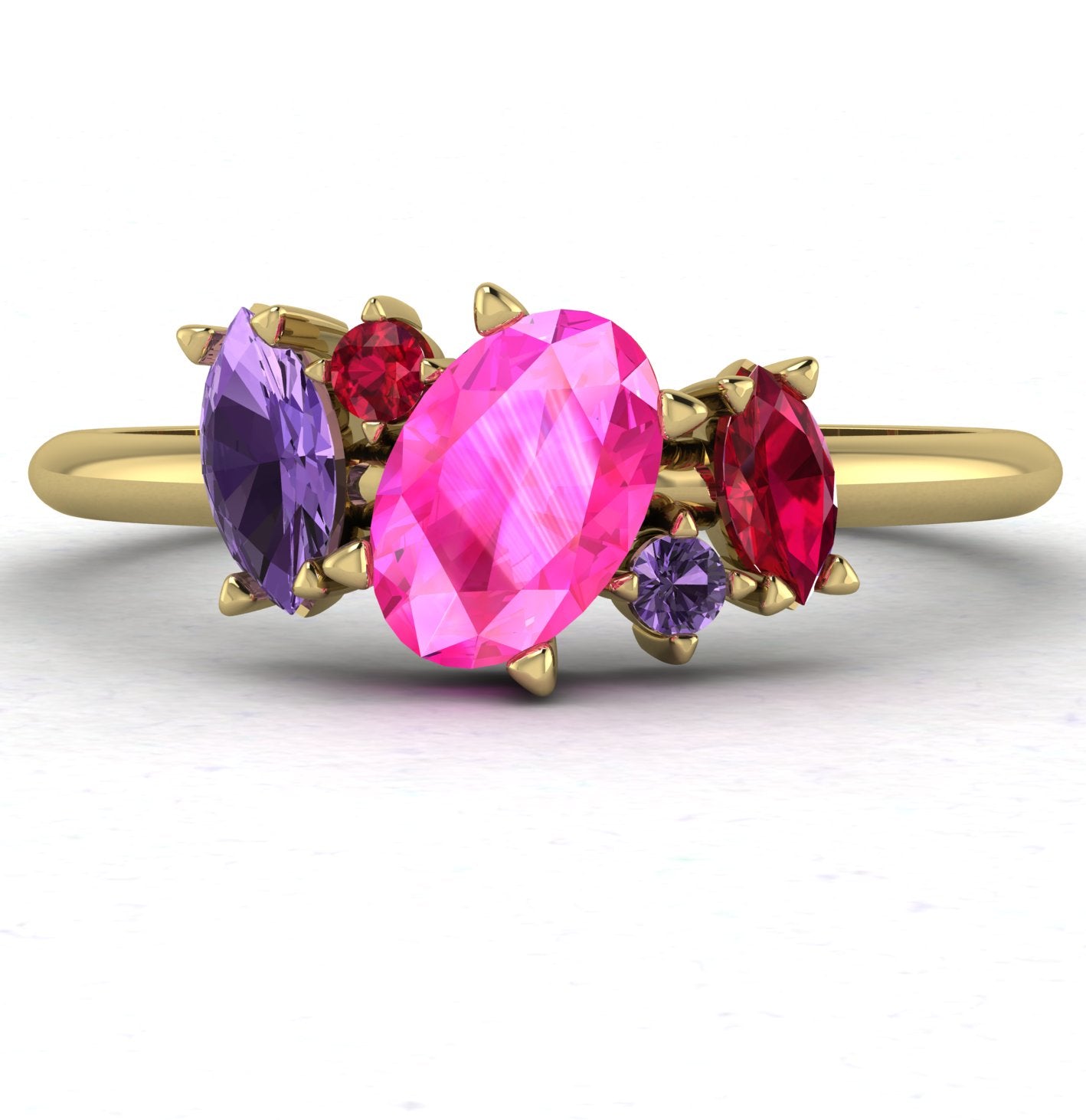 Front view of the Atlantis ring featuring an asymmetrical cluster of pink and violet sapphires paired with a ruby in 18ct yellow gold.