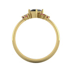 A view through the centre of the yellow gold band, detailing the thickness of the ring and the architectural height of the asymmetrical black diamond and ruby settings.