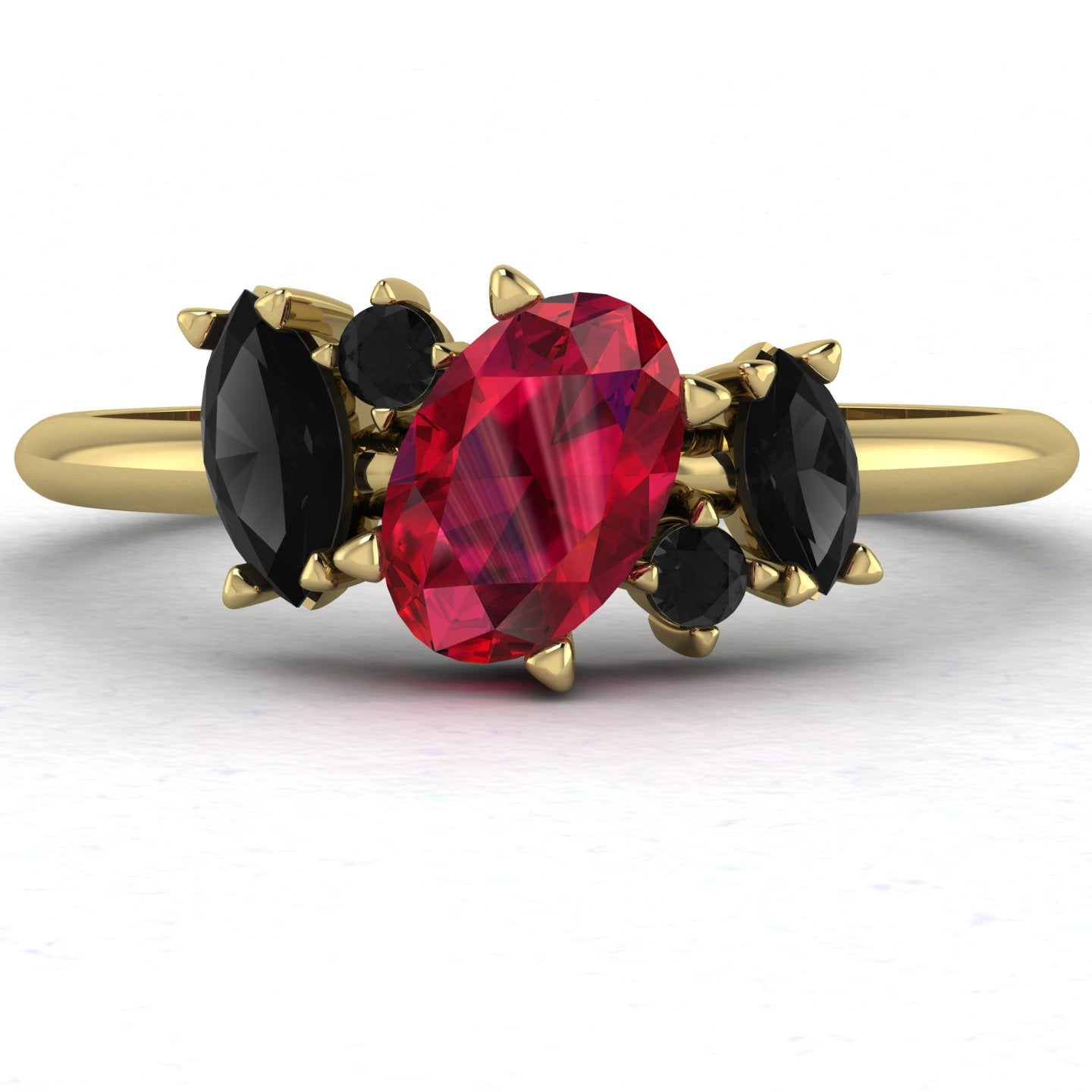 view of the Atlantis engagement ring in 18ct yellow gold, featuring a central pear-shaped black diamond surrounded by an asymmetrical cluster of crimson rubies and white diamonds.
