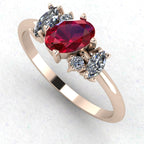 An angled perspective of the Atlantis ruby ring, highlighting the organic, handmade setting and the striking tonal contrast between the crimson stones and the rose gold band.