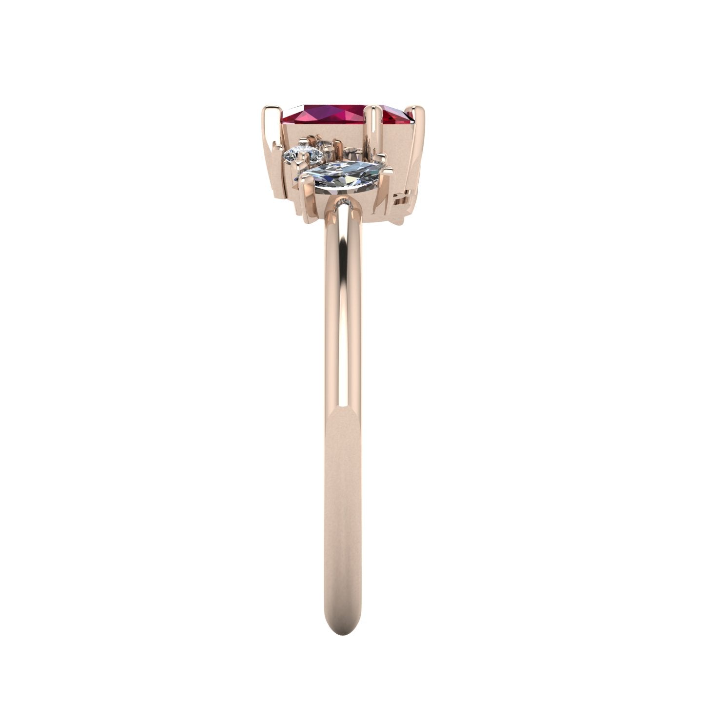 A side profile shot of the Atlantis asymmetrical ring, showcasing the hand-carved, textured rose gold band and the varying heights of the hand-set ruby and diamond cluster.