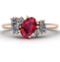 Front view of the Atlantis engagement ring, featuring a bespoke asymmetrical cluster of rich red rubies and sparkling white diamonds in warm 18ct rose gold.