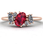 Front view of the Atlantis engagement ring, featuring a bespoke asymmetrical cluster of rich red rubies and sparkling white diamonds in warm 18ct rose gold.