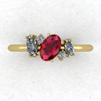 A top-down view of the Atlantis engagement ring, featuring an asymmetrical cluster of vibrant red rubies and sparkling diamonds set in 18ct yellow gold.