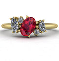 Front view of the Atlantis engagement ring, featuring an asymmetrical cluster of vibrant red rubies and sparkling diamonds set in 18ct yellow gold.