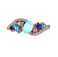 Top view of the Atlantis Storm 18ct rose gold ring featuring a central aquamarine accented by blue sapphires, zircons, and diamonds.
