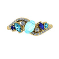 Top view of the Atlantis Storm 18ct yellow gold ring with a central aquamarine and blue sapphire cluster.