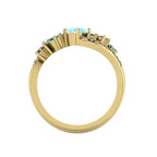 Through-finger view of the Atlantis Storm aquamarine ring in 18ct yellow gold showing the setting and hallmark.