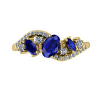 Top-down hero shot of the Atlantis Storm 18ct yellow gold ring featuring a cluster of deep blue sapphires and brilliant white diamonds.