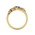 Through-finger technical view of the Atlantis Storm blue sapphire ring in 18ct yellow gold, showing the structural setting.