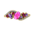 Top-down hero shot of the Atlantis Storm 18ct yellow gold ring cluster, featuring vibrant rubies, pink and violet sapphires, and white diamonds.