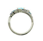 Through view of the Atlantis Storm ring highlighting the cluster of blue aquamarine and pavé set diamonds.